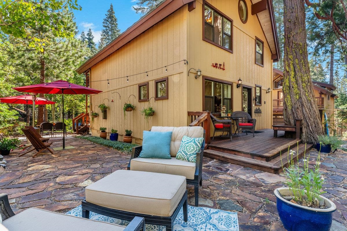 4465 North Ridge Road Carnelian Bay, CA 96140 - Photo 14 of 28 a view of a patio with a table and chairs under an umbrella