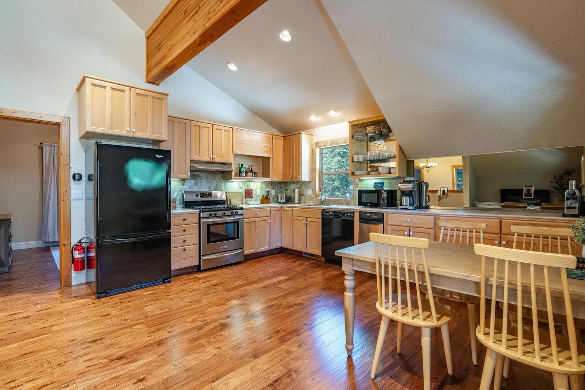 4465 North Ridge Road Carnelian Bay, CA 96140 - Photo 17 of 28 a kitchen with stainless steel appliances kitchen island granite countertop a refrigerator and a stove top oven