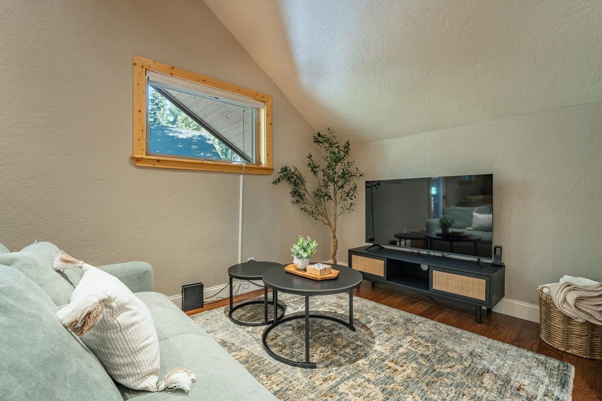4465 North Ridge Road Carnelian Bay, CA 96140 - Photo 18 of 28 a living room with furniture and a flat screen tv