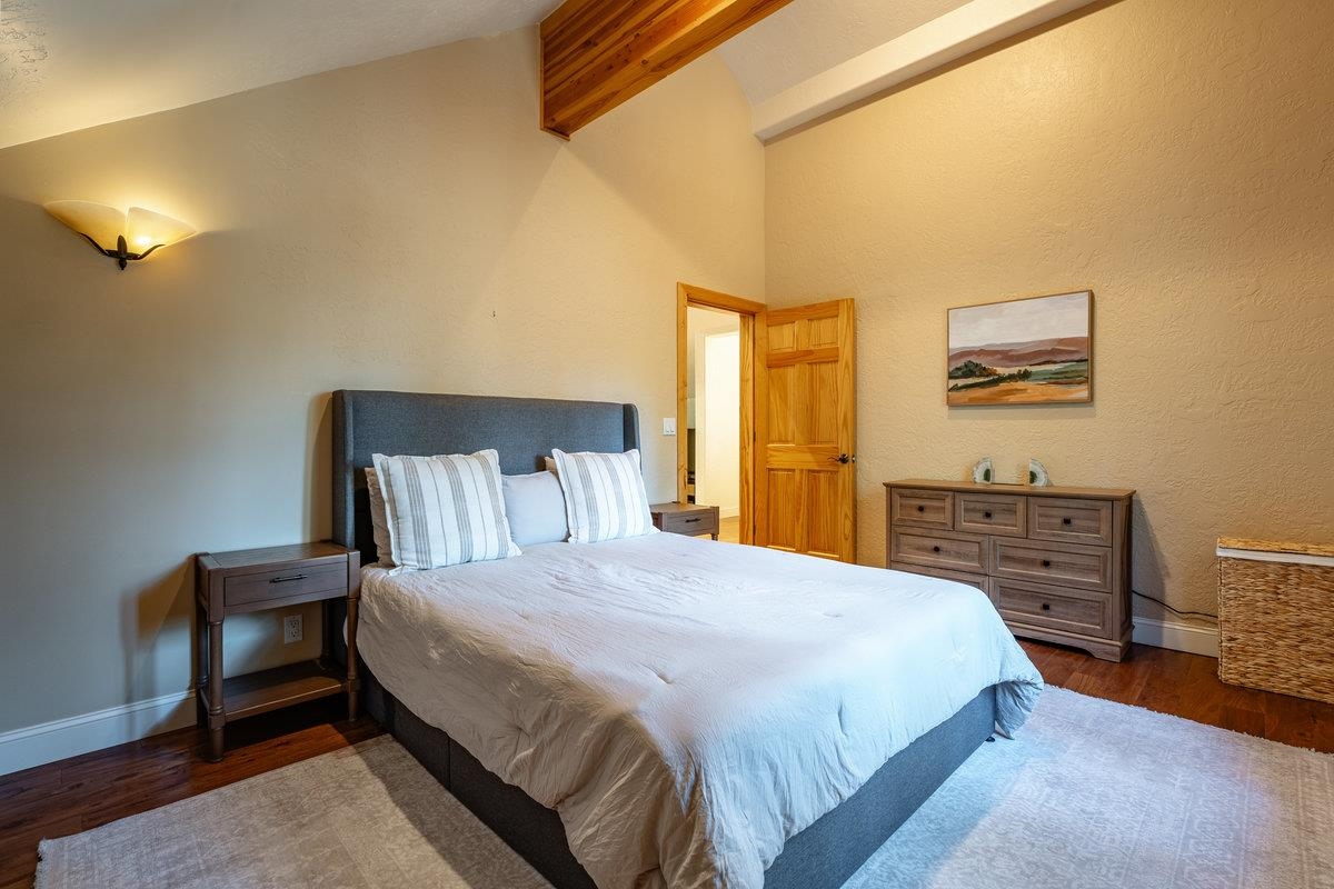 4465 North Ridge Road Carnelian Bay, CA 96140 - Photo 19 of 28 a bedroom with a bed table and chair