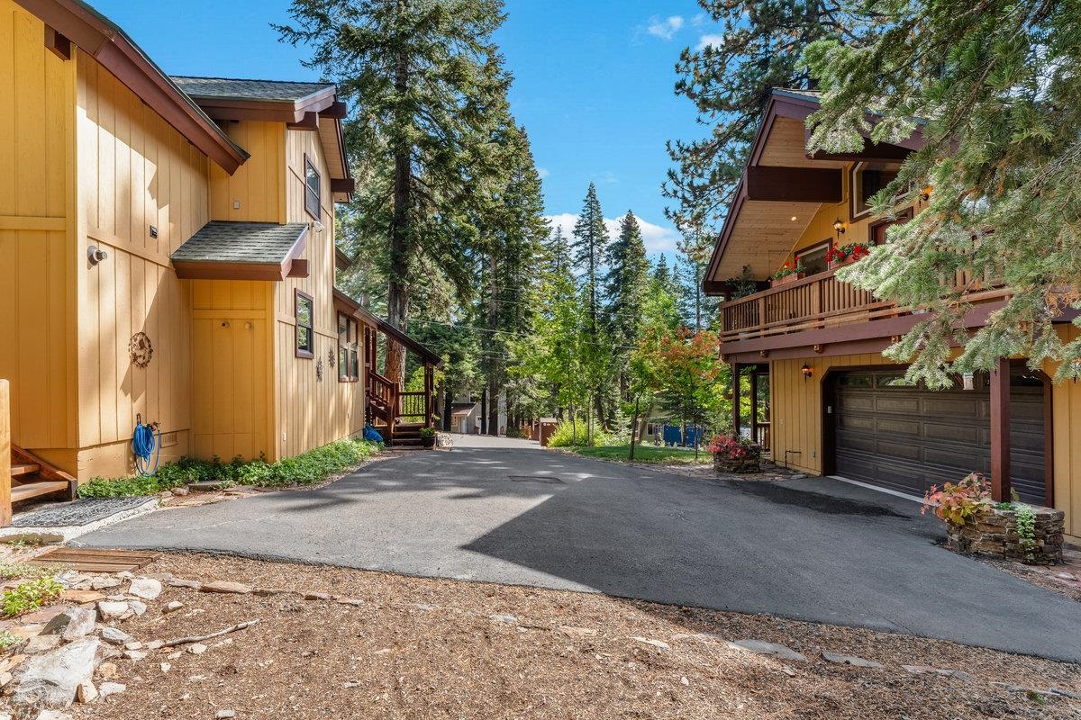 4465 North Ridge Road Carnelian Bay, CA 96140 - Photo 22 of 28 a front view of a house with a yard and garage