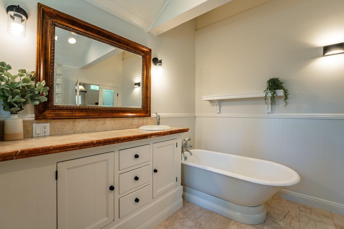 4465 North Ridge Road Carnelian Bay, CA 96140 - Photo 8 of 28 a bathroom with a granite countertop toilet a sink and mirror