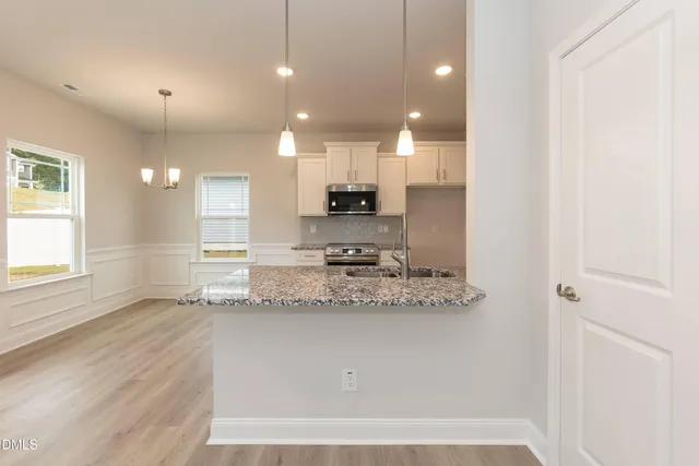 a kitchen with granite countertop stainless steel appliances and sink