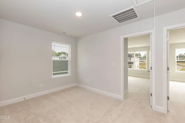 a bathroom with a bathtub shower sink vanity mirror and toilet