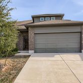 a front view of a house with garage