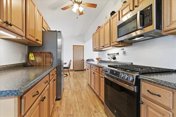 a kitchen with stainless steel appliances granite countertop a stove and a sink