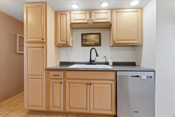 a kitchen with white cabinets and a sink