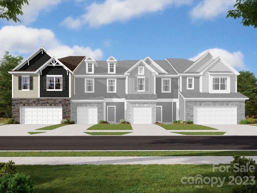 6043 Rizer Drive Charlotte, NC 28269 - Photo 1 of 4 a front view of a house with a garden and lake view