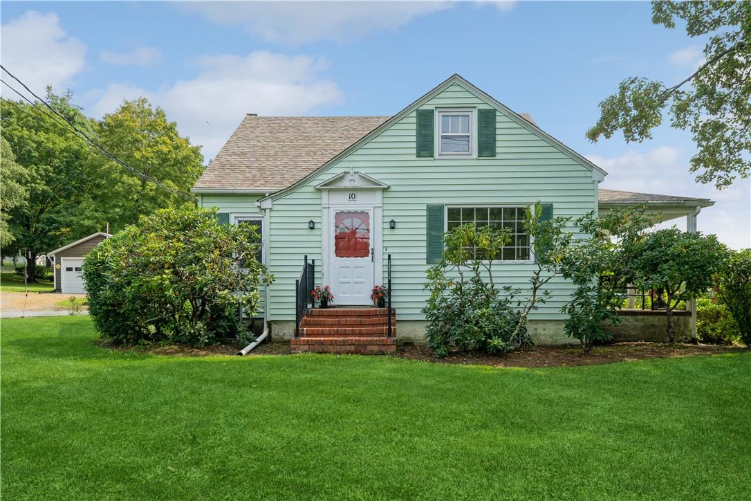a front view of house with yard and green space