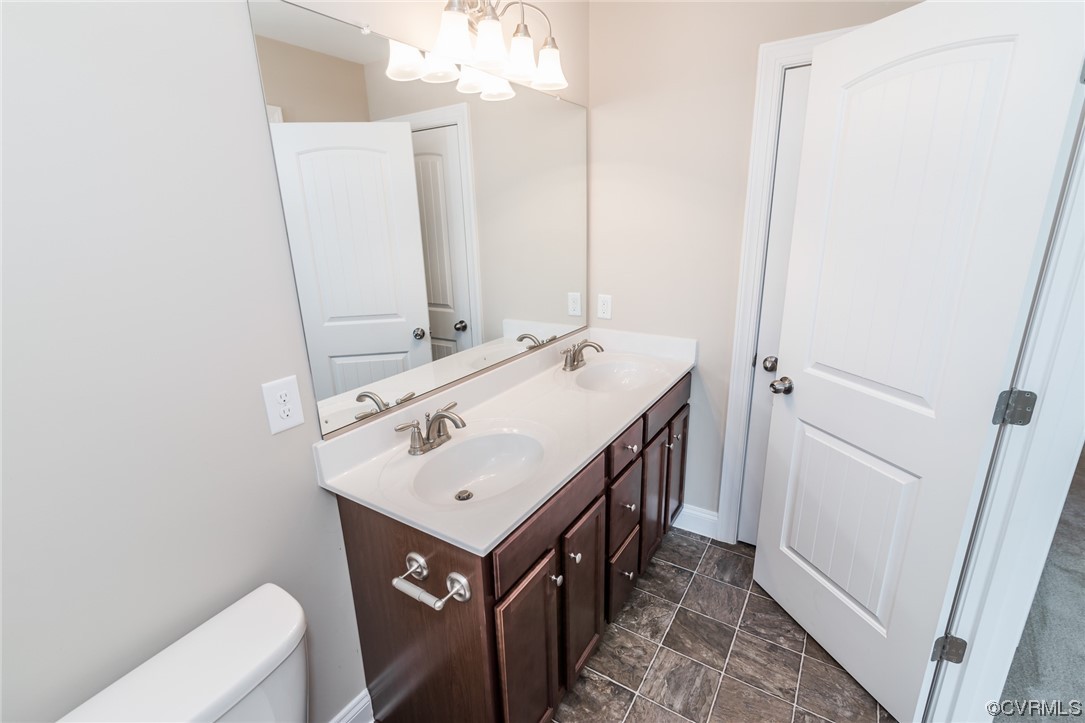 6173 Belay Drive Richmond, VA 23234 - Photo 11 of 17 a bathroom with a sink a toilet and mirror