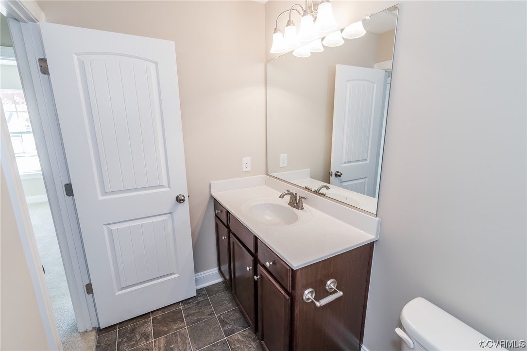 6173 Belay Drive Richmond, VA 23234 - Photo 15 of 17 a bathroom with a sink a toilet a mirror and vanity