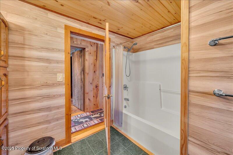 1338 Whites Ferry Road Falls, PA 18615 - Photo 17 of 46 a bathroom with a glass shower door