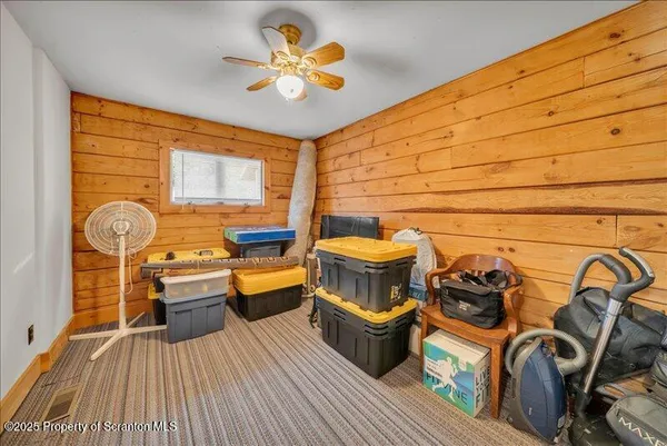 a view of a hallway with wooden walls