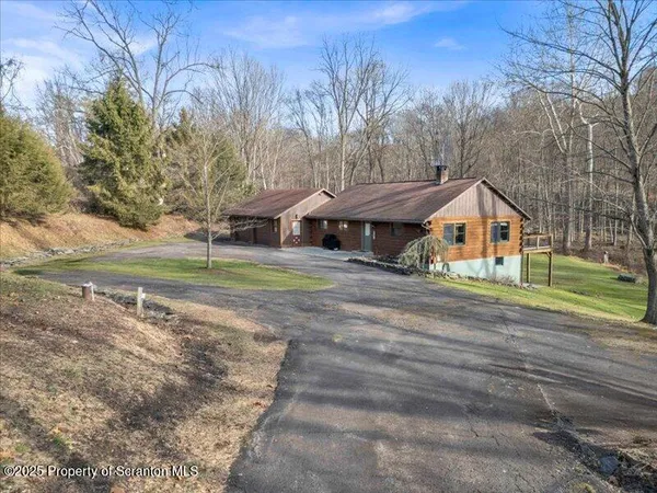 a view of a house with a yard and garage