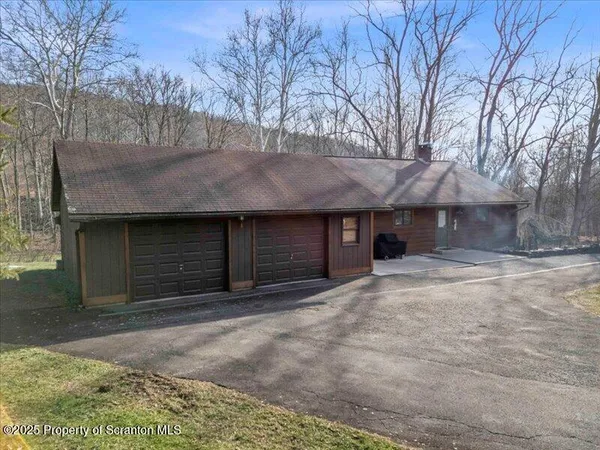 a view of garage with wooden fence