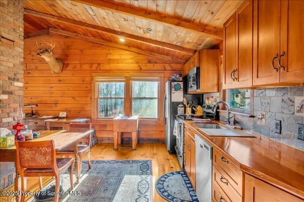 a kitchen with stainless steel appliances granite countertop sink stove and cabinets
