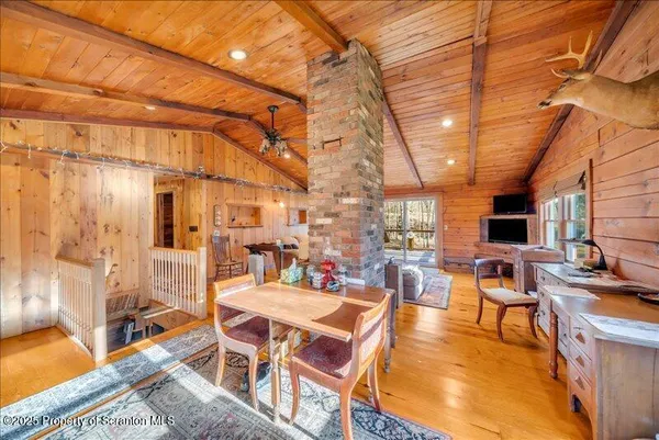 a living room with fireplace furniture and a wooden floor