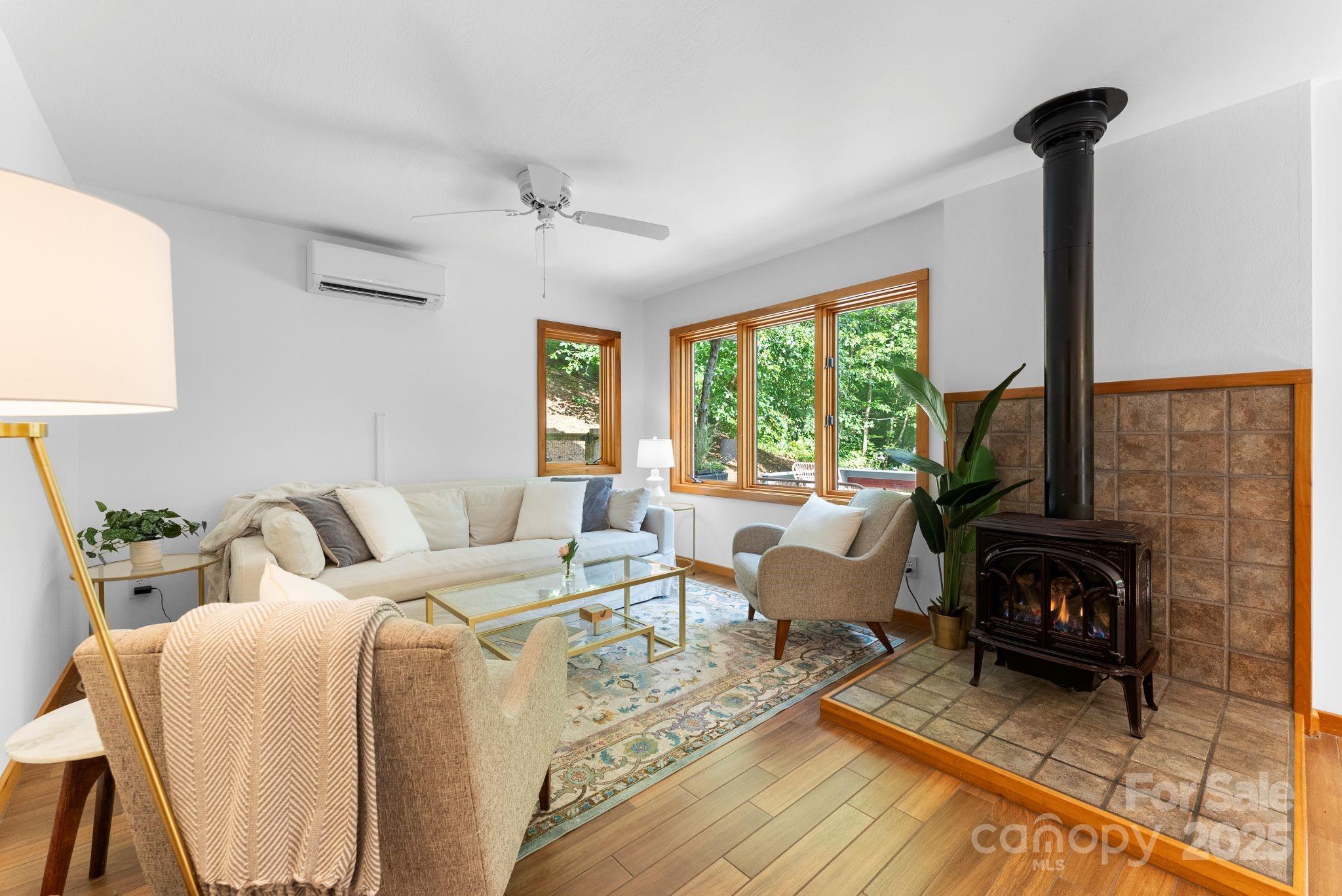 48 Black Oak Forest Road Fairview, NC 28730 - Photo 12 of 48 a living room with furniture large window and a fireplace