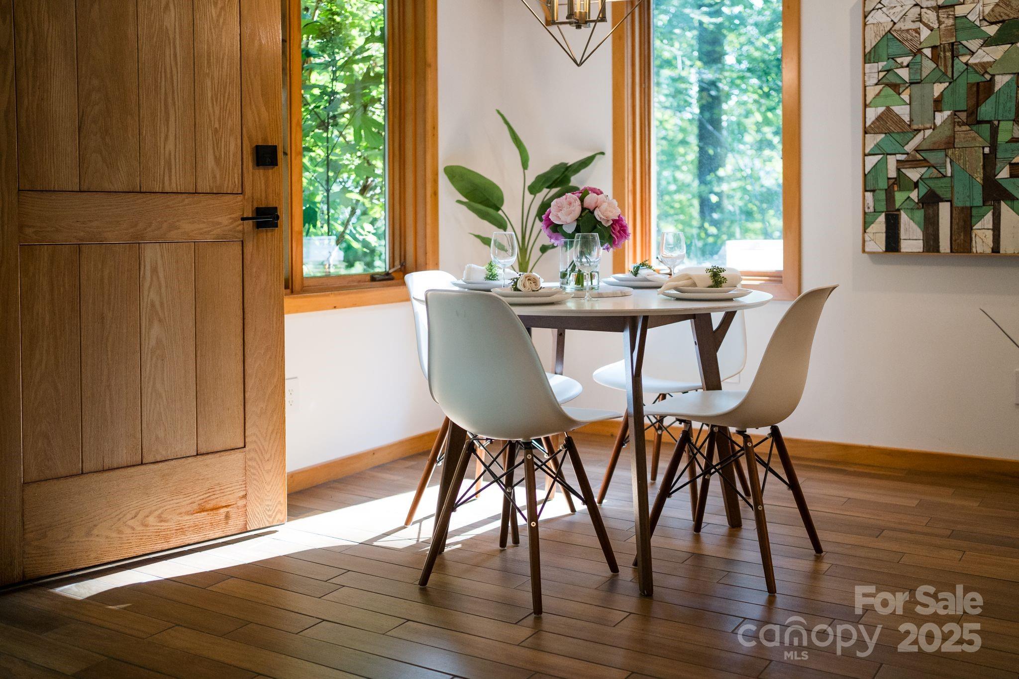 48 Black Oak Forest Road Fairview, NC 28730 - Photo 19 of 48 a view of a dining room with furniture window and wooden floor