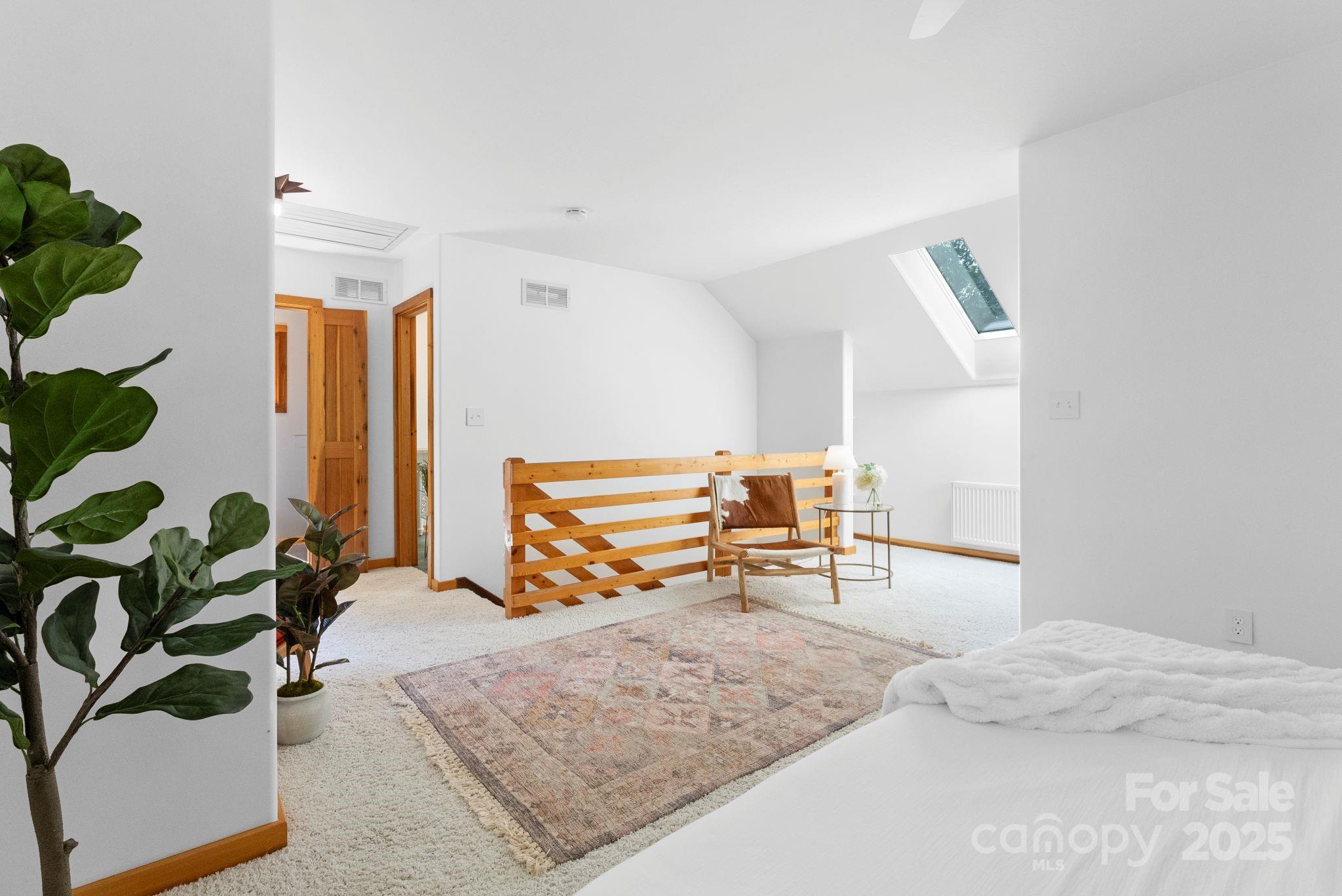 48 Black Oak Forest Road Fairview, NC 28730 - Photo 26 of 48 a bedroom with furniture and a potted plant
