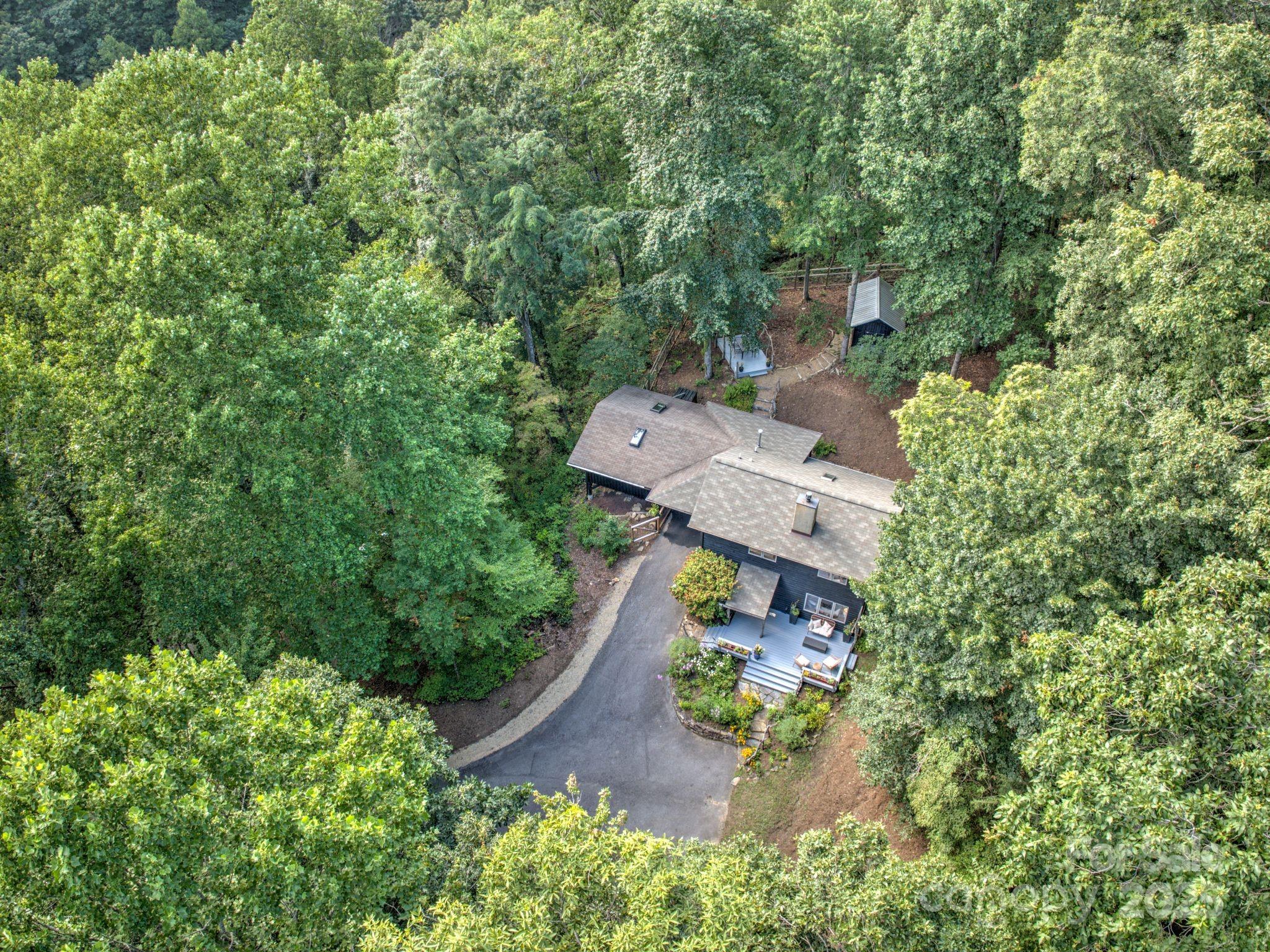 48 Black Oak Forest Road Fairview, NC 28730 - Photo 3 of 48 an aerial view of house with yard swimming pool and outdoor seating