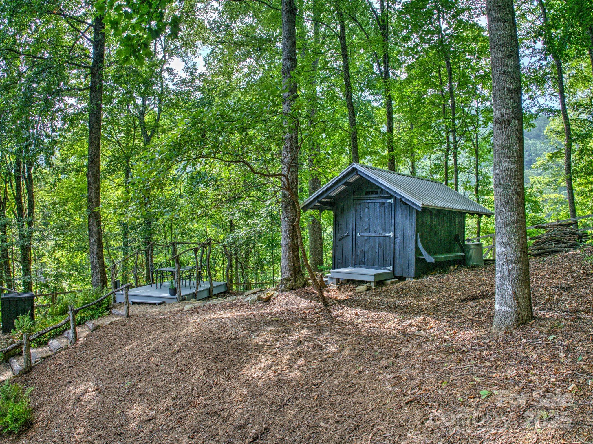 48 Black Oak Forest Road Fairview, NC 28730 - Photo 38 of 48 a wooden house with large trees and wooden fence