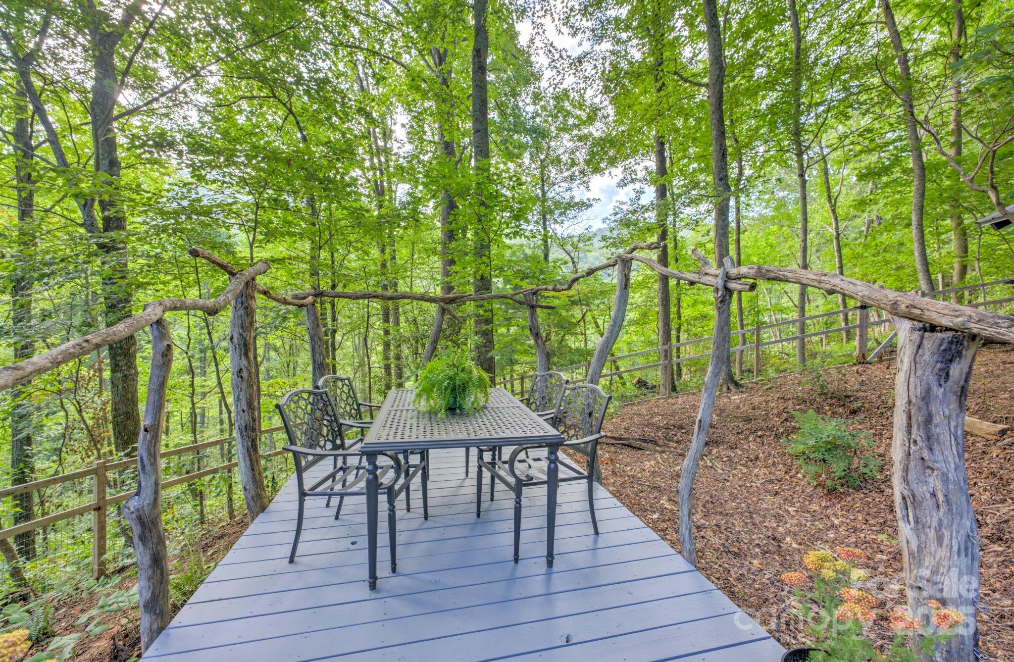 48 Black Oak Forest Road Fairview, NC 28730 - Photo 41 of 48 a view of a chairs and table on the wooden deck