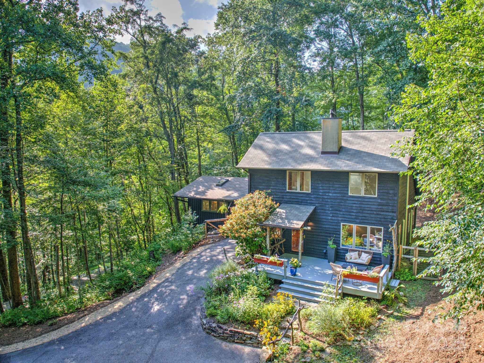 48 Black Oak Forest Road Fairview, NC 28730 - Photo 5 of 48 a view of a brick house with a yard