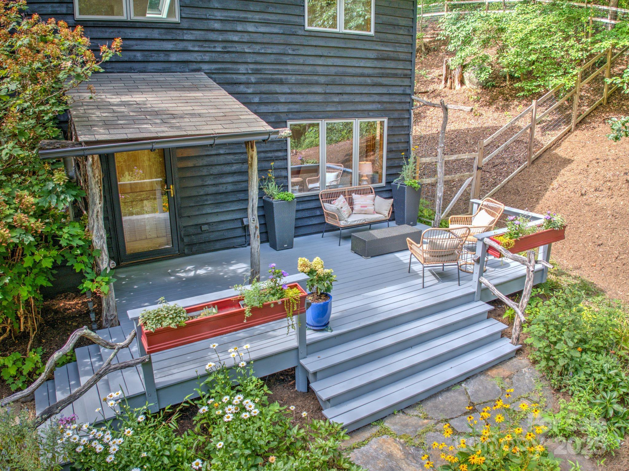 48 Black Oak Forest Road Fairview, NC 28730 - Photo 6 of 48 a backyard of a house with seating space and trees