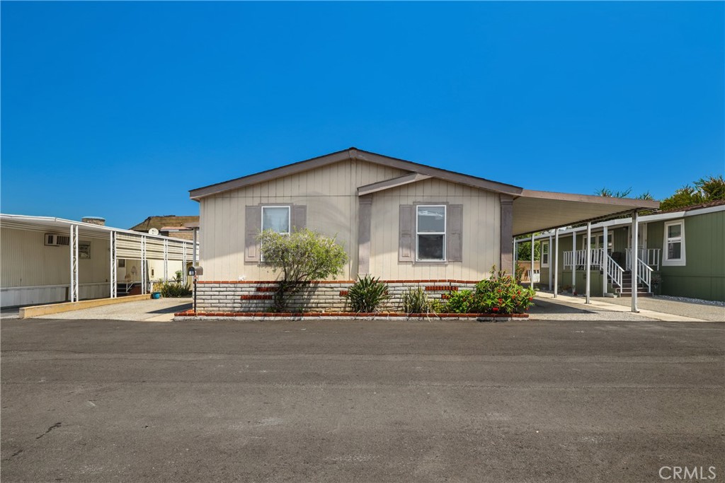 1166 South Riverside Avenue, Unit 81 Rialto, CA 92376 - Photo 1 of 1 a front view of a house with a yard