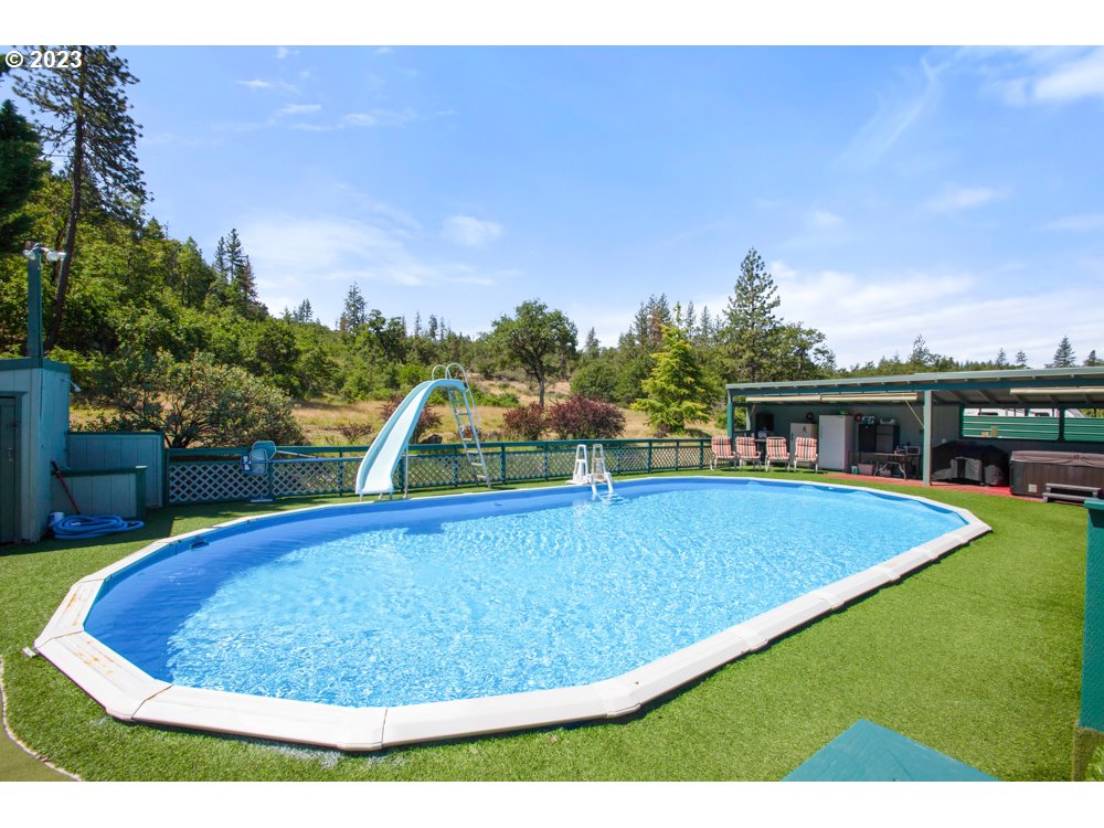890 Crowfoot Road Eagle Point, OR 97524 - Photo 14 of 48 a view of a swimming pool with an outdoor seating