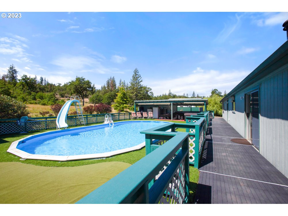 890 Crowfoot Road Eagle Point, OR 97524 - Photo 15 of 48 a view of a swimming pool with an outdoor seating