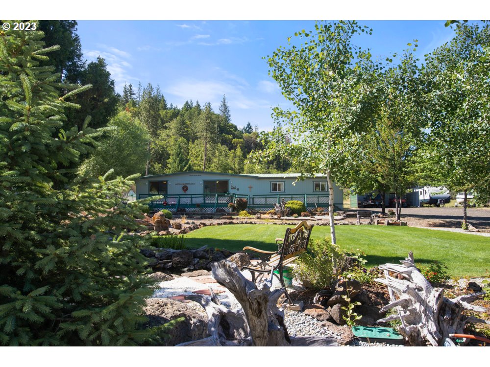 890 Crowfoot Road Eagle Point, OR 97524 - Photo 23 of 48 a front view of a house with garden and trees