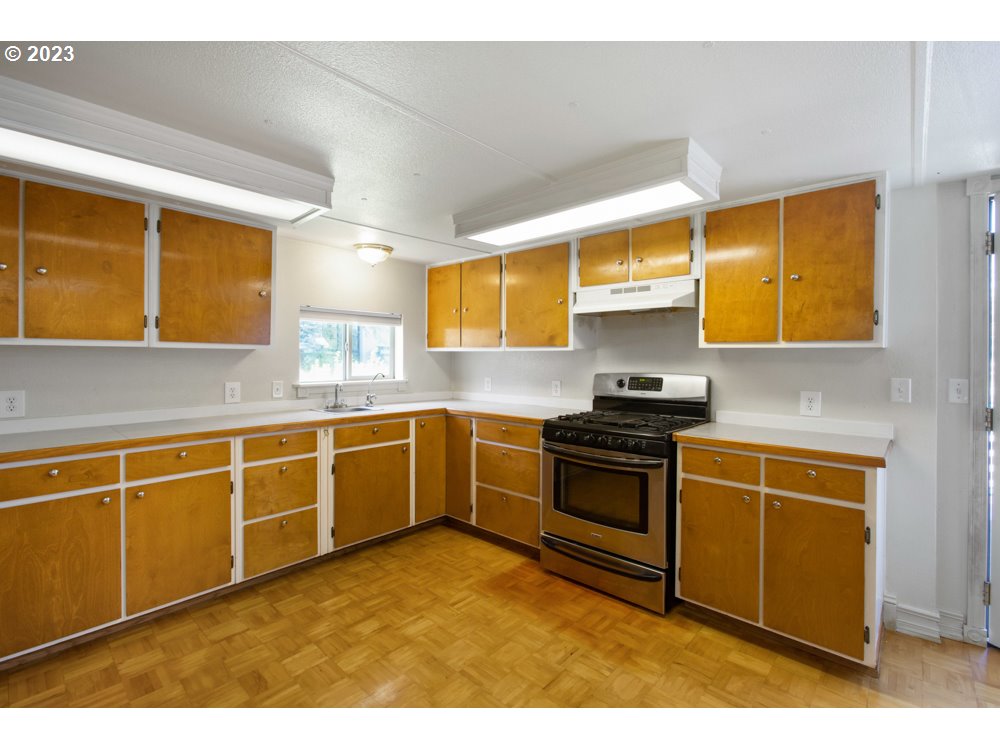 890 Crowfoot Road Eagle Point, OR 97524 - Photo 31 of 48 a kitchen with stainless steel appliances granite countertop a stove a sink and a microwave
