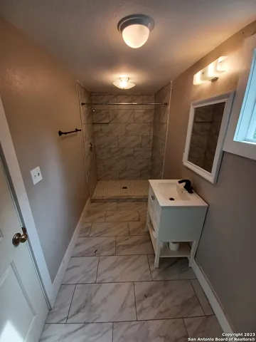 a bathroom with a sink a toilet and mirror