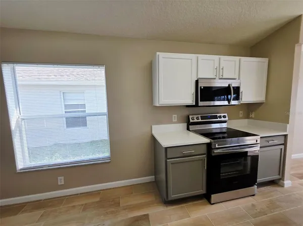 a kitchen with a stove and a microwave