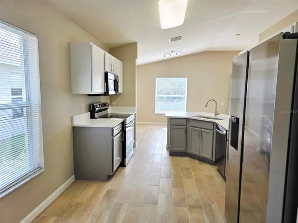 a kitchen with stainless steel appliances a sink stove and a refrigerator