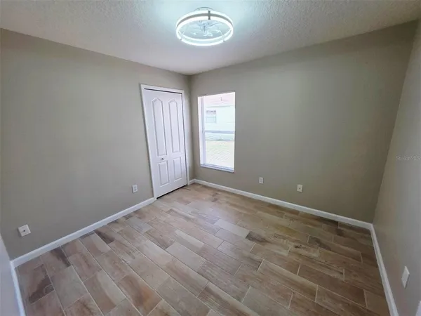 a bathroom with a sink a toilet a mirror and shower