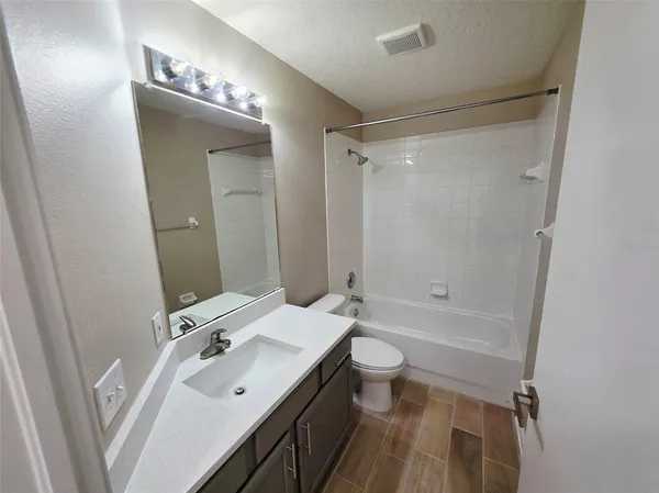 a bathroom with a bathtub and shower