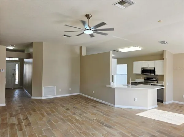 a view of kitchen with sink microwave and stove