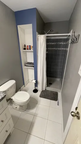 a bathroom with a toilet a sink and shower