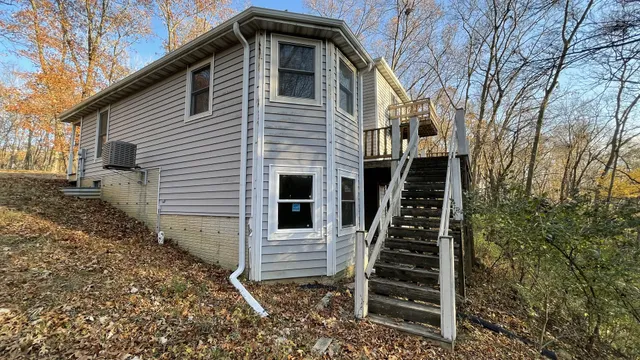 a front view of a house with stairs