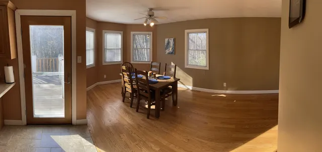 a dining room with furniture and window