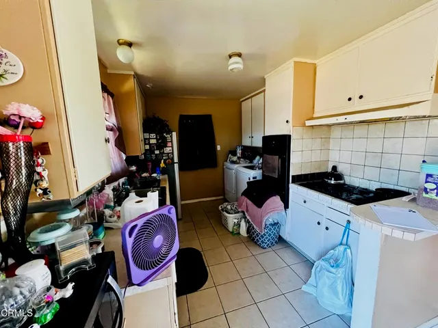 a kitchen with a sink appliances and cabinets