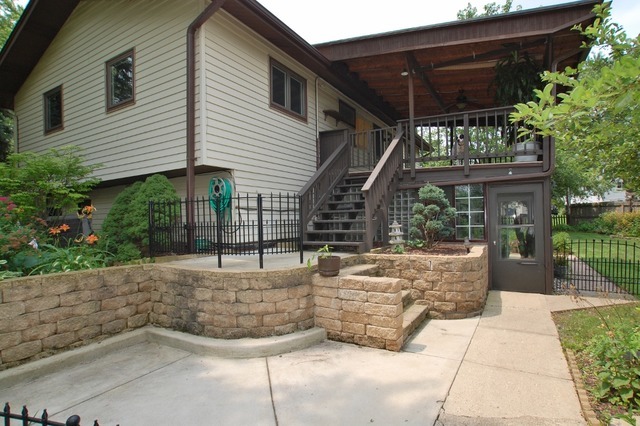 400 Frederick Lane Hoffman Estates, IL 60169 - Photo 30 of 34 a view of a patio with table and chairs potted plants and floor to ceiling window and potted plants
