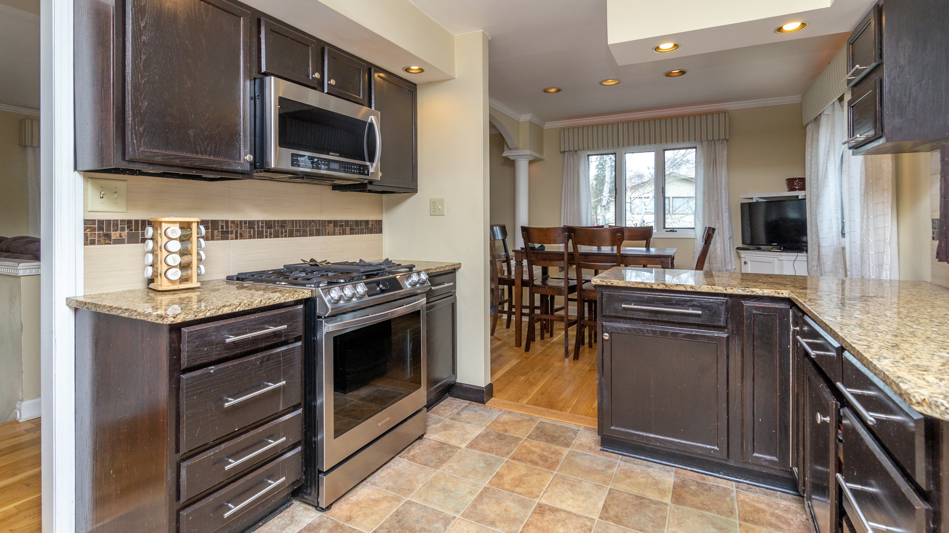 400 Frederick Lane Hoffman Estates, IL 60169 - Photo 7 of 34 a kitchen with stainless steel appliances granite countertop a stove top oven microwave and refrigerator
