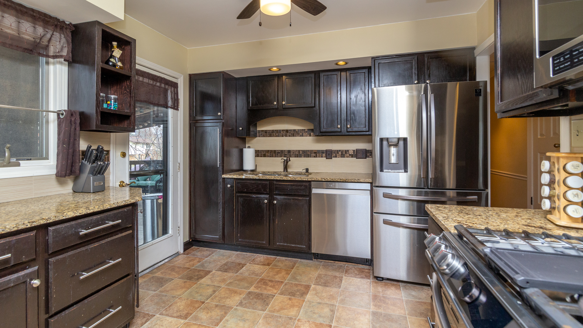 400 Frederick Lane Hoffman Estates, IL 60169 - Photo 8 of 34 a kitchen with stainless steel appliances granite countertop a refrigerator a stove and a sink