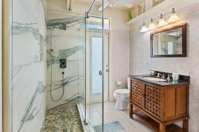 a bathroom with a sink toilet and shower