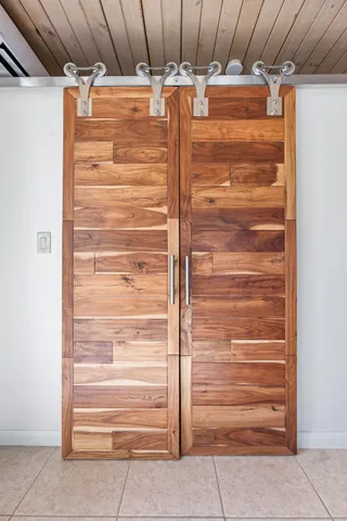 a view of a patio with couches and table and chairs under an umbrella