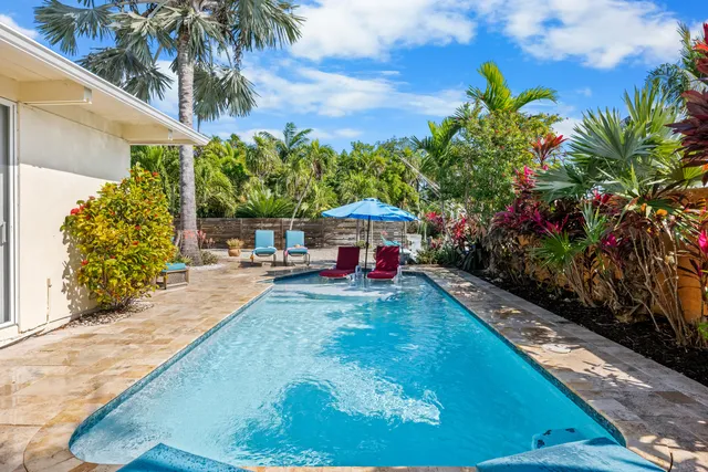 a view of a backyard with plants and outdoor seating
